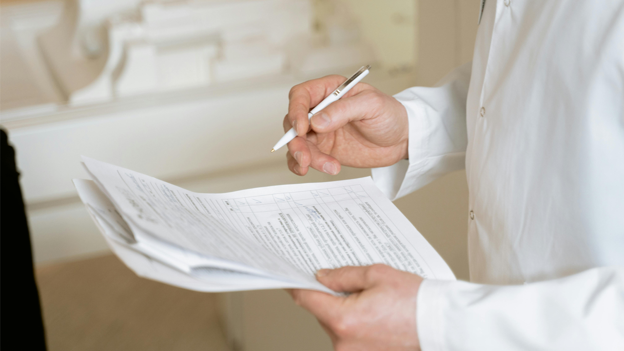 An image of Toronto rental agent Marco Pedri reviewing supporting documents at a rental property in Toronto, Ontario.