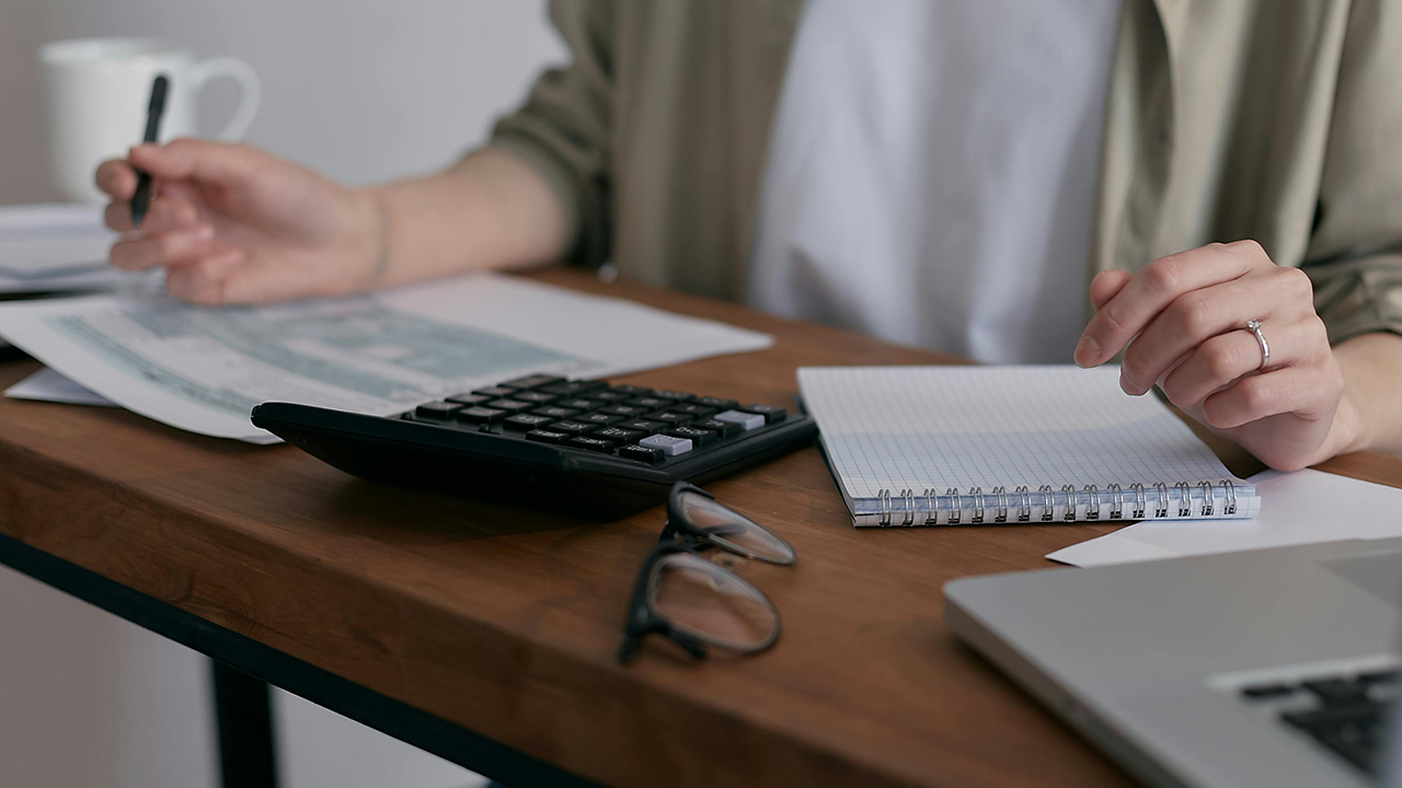 An image of a Toronto investor completing calculations of their rental property.