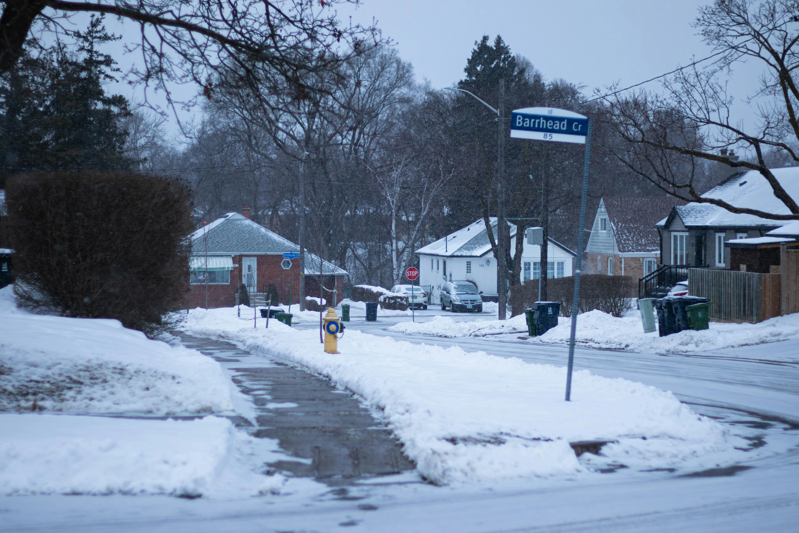 An image of a street name sign in Toronto during the winter.