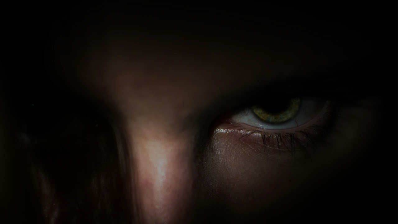 Signs of a bad landlord - an eerie image of a face where most of the face is covered in shadows, but the eye of a person is visible.
