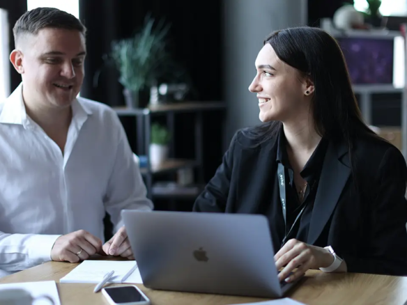 An image of a rental agent and property manager sitting side by side near a computer.